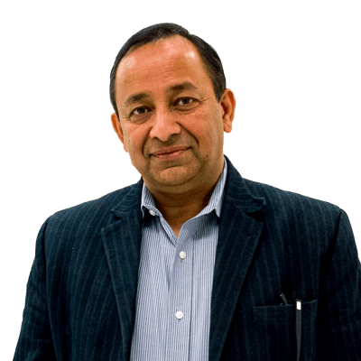 Portrait of a South Asian man in a pinstriped suit jacket looking into the camera with a slight smile.