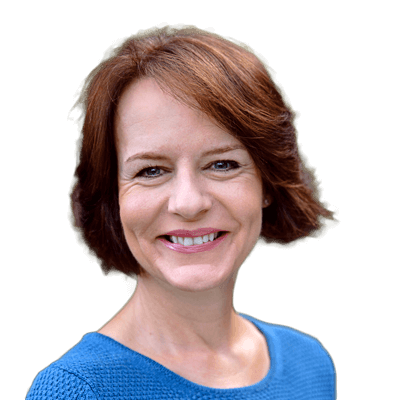 Portrait of a European woman turned slightly toward the right of the frame, looking into the camera with a large smile.